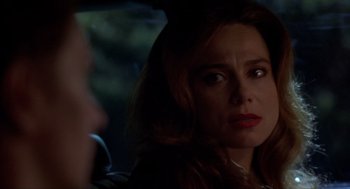Movie still from “Romeo Is Bleeding” (1993), directed by Peter Medak – A person with long brown hair; Close Up shot, Over the shoulder angle