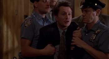 Movie still from “Romeo Is Bleeding” (1993), directed by Peter Medak – A group of men standing next to each other in a room; Medium shot, Low angle