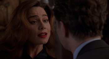 Movie still from “Romeo Is Bleeding” (1993), directed by Peter Medak – A person talking to another person; Close Up shot, Over the shoulder angle