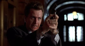 Movie still from “Romeo Is Bleeding” (1993), directed by Peter Medak – A man holding a gun with blood all over his face; Close Up shot, Low angle