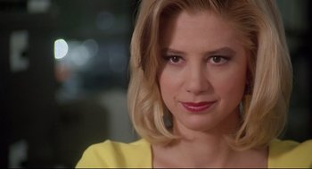 Movie still from “Romy and Michele's High School Reunion” (1997), directed by David Mirkin – A person wearing a yellow shirt; Close Up shot, Over the shoulder angle