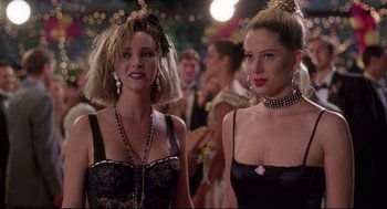 Movie still from “Romy and Michele's High School Reunion” (1997), directed by David Mirkin – A couple of women standing next to each other; Close Up shot, Over the shoulder angle
