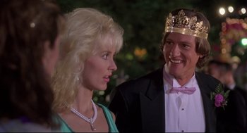 Movie still from “Romy and Michele's High School Reunion” (1997), directed by David Mirkin – A man and a woman in formal wear at a party; Close Up shot, Over the shoulder angle