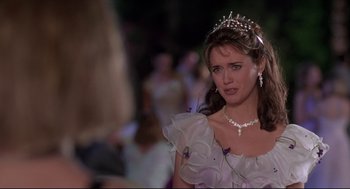 Movie still from “Romy and Michele's High School Reunion” (1997), directed by David Mirkin – A woman wearing a tiara and a white dress; Close Up shot, Over the shoulder angle