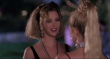 Movie still from “Romy and Michele's High School Reunion” (1997), directed by David Mirkin – A woman with a big smile on her face; Close Up shot, Over the shoulder angle