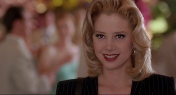 Movie still from “Romy and Michele's High School Reunion” (1997), directed by David Mirkin – A person wearing a suit; Close Up shot, Over the shoulder angle