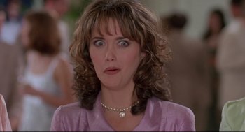 Movie still from “Romy and Michele's High School Reunion” (1997), directed by David Mirkin – A person wearing a purple shirt; Close Up shot, Low angle