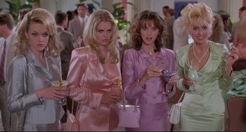 Movie still from “Romy and Michele's High School Reunion” (1997), directed by David Mirkin – A group of women standing next to each other holding drinks; Medium shot, Low angle