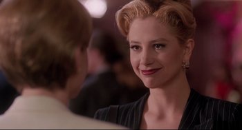 Movie still from “Romy and Michele's High School Reunion” (1997), directed by David Mirkin – A person wearing a black shirt; Close Up shot, Over the shoulder angle