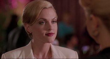 Movie still from “Romy and Michele's High School Reunion” (1997), directed by David Mirkin – A person wearing a suit; Close Up shot, Over the shoulder angle
