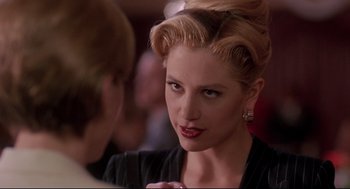Movie still from “Romy and Michele's High School Reunion” (1997), directed by David Mirkin – A beautiful woman with blonde ringlets talking to another woman; Close Up shot, Over the shoulder angle