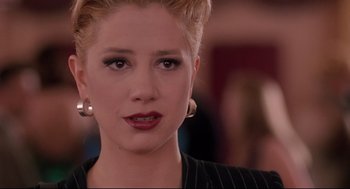 Movie still from “Romy and Michele's High School Reunion” (1997), directed by David Mirkin – A person wearing a suit; Close Up shot, Over the shoulder angle