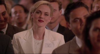 Movie still from “Romy and Michele's High School Reunion” (1997), directed by David Mirkin – A woman in a white jacket is looking to her left; Close Up shot, Over the shoulder angle