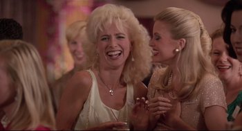 Movie still from “Romy and Michele's High School Reunion” (1997), directed by David Mirkin – Two women are laughing together at an event; Close Up shot, Low angle