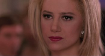Movie still from “Romy and Michele's High School Reunion” (1997), directed by David Mirkin – A woman's face with a lot of makeup on; Close Up shot, Over the shoulder angle