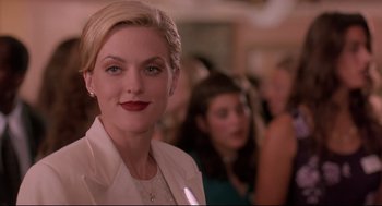 Movie still from “Romy and Michele's High School Reunion” (1997), directed by David Mirkin – A person wearing a white jacket; Close Up shot, Over the shoulder angle