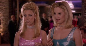 Movie still from “Romy and Michele's High School Reunion” (1997), directed by David Mirkin – A couple of women standing next to each other; Close Up shot, Low angle