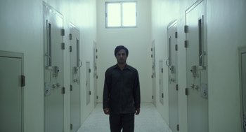 A man standing in a room with many doors