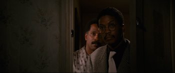 Movie still from “'Round Midnight” (1986), directed by Bertrand Tavernier – A couple of men standing next to each other in a room; Close Up shot, Low angle