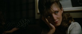 Movie still from “'Round Midnight” (1986), directed by Bertrand Tavernier – A person sitting in a room; Close Up shot, High angle