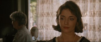 Movie still from “'Round Midnight” (1986), directed by Bertrand Tavernier – A person wearing a dress; Close Up shot, Over the shoulder angle
