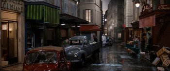 Movie still from “'Round Midnight” (1986), directed by Bertrand Tavernier – An old truck parked in the middle of a street; Wide shot, High angle