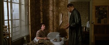 Movie still from “'Round Midnight” (1986), directed by Bertrand Tavernier – Two men sitting on a bed talking to each other; Medium shot, Low angle