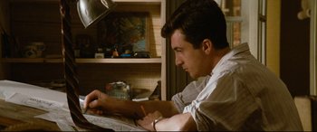 Movie still from “'Round Midnight” (1986), directed by Bertrand Tavernier – A man writing on a piece of paper in a kitchen; Close Up shot, High angle