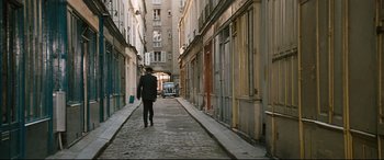 Movie still from “'Round Midnight” (1986), directed by Bertrand Tavernier – A man walking down a narrow alley way; Extreme Wide shot, High angle