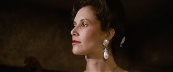 Movie still from “'Round Midnight” (1986), directed by Bertrand Tavernier – A woman wearing a pair of large pearl earrings; Close Up shot, Low angle