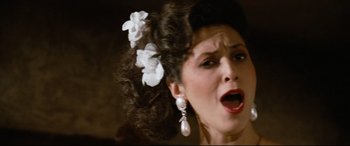 Movie still from “'Round Midnight” (1986), directed by Bertrand Tavernier – A person with a flower in her hair; Close Up shot, Low angle