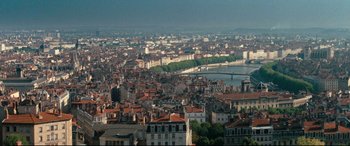Movie still from “'Round Midnight” (1986), directed by Bertrand Tavernier – An aerial view of a large city with a bridge in the background; Extreme Wide shot, High angle