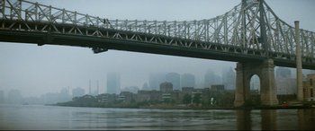 Movie still from “'Round Midnight” (1986), directed by Bertrand Tavernier – A view of a bridge over a body of water; Extreme Wide shot, Low angle