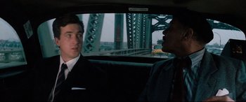 Movie still from “'Round Midnight” (1986), directed by Bertrand Tavernier – Two men in suits in the back of a car; Medium shot, Over the shoulder angle