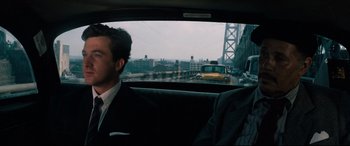 Movie still from “'Round Midnight” (1986), directed by Bertrand Tavernier – Two men in suits in the back seat of a car; Medium shot, Over the shoulder angle