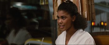 Movie still from “'Round Midnight” (1986), directed by Bertrand Tavernier – A young woman sitting on a bus looking out the window; Close Up shot, Over the shoulder angle