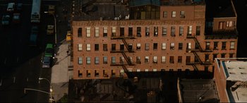 Movie still from “'Round Midnight” (1986), directed by Bertrand Tavernier – An aerial view of an apartment building with fire escapes; Extreme Wide shot, Overhead angle