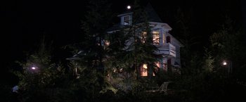 Movie still from “Roxanne” (1987), directed by Fred Schepisi – A large white house sitting next to a tree; Extreme Wide shot, Low angle