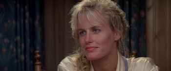 Movie still from “Roxanne” (1987), directed by Fred Schepisi – A woman with blonde curly hair wearing a white shirt; Close Up shot, Over the shoulder angle