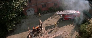 Movie still from “Roxanne” (1987), directed by Fred Schepisi – A fire hydrant that has been set on fire; Extreme Wide shot, High angle