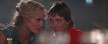 Movie still from “Roxanne” (1987), directed by Fred Schepisi – Two women looking at one another in the dark; Close Up shot, Over the shoulder angle