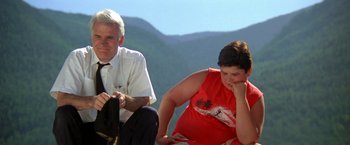 Movie still from “Roxanne” (1987), directed by Fred Schepisi – An older man sitting next to a young woman; Medium shot, Low angle