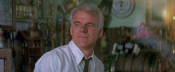 Movie still from “Roxanne” (1987), directed by Fred Schepisi – A person wearing a shirt and a tie; Close Up shot, Over the shoulder angle