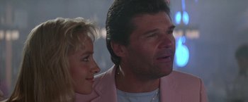 Movie still from “Roxanne” (1987), directed by Fred Schepisi – A man and a woman wearing pink jackets looking at one another; Close Up shot, Low angle