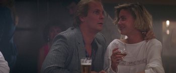 Movie still from “Roxanne” (1987), directed by Fred Schepisi – A person holding a drink; Close Up shot, Over the shoulder angle