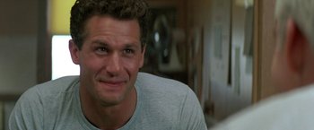 Movie still from “Roxanne” (1987), directed by Fred Schepisi – A person smiling for the camera; Close Up shot, Low angle