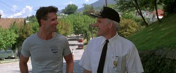 Movie still from “Roxanne” (1987), directed by Fred Schepisi – Two men talking on the side of the road; Close Up shot, Over the shoulder angle