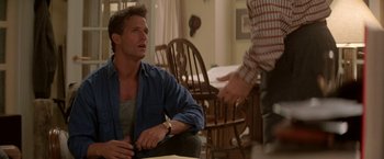 Movie still from “Roxanne” (1987), directed by Fred Schepisi – A man sitting in front of another man in a room; Medium shot, Over the shoulder angle