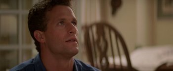 Movie still from “Roxanne” (1987), directed by Fred Schepisi – A person sitting in a chair; Close Up shot, Low angle