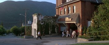 Movie still from “Roxanne” (1987), directed by Fred Schepisi – A group of men playing baseball in front of a building; Extreme Wide shot, High angle